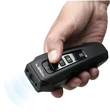 Hand pressing the button on the NoBark Ultra handheld trainer